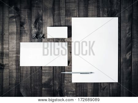 Blank stationery set on wooden table background. Blank letterhead business cards envelope and pen. ID template. Mockup for branding identity. Blank letterhead business card envelope and pen. Top view.
