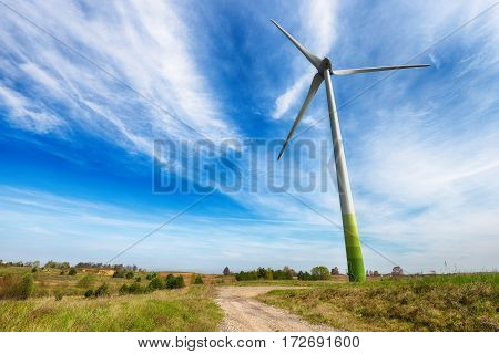 wind turbines in fields under blue sky