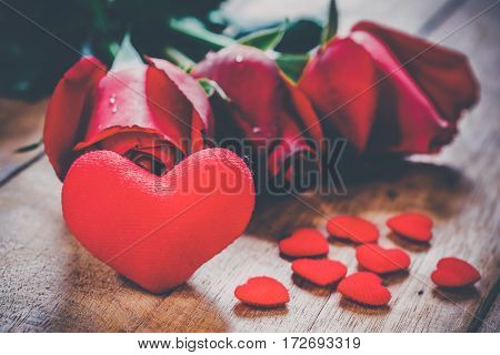 Red hearts and roses on wooden board.Valentines Day background concept Wedding day.Vintage tone