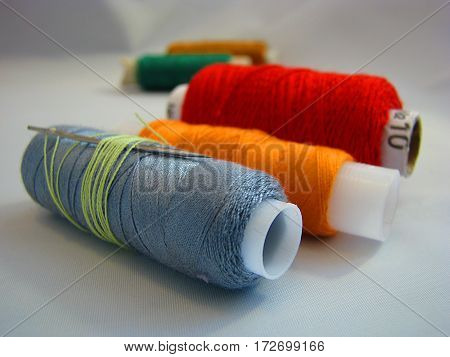 workflow sewing colored thread in the home on a white background