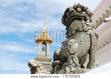 grey stone lion model with bell tower background