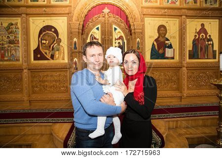 ALMATY KAZAKHSTAN - DECEMBER 17: Christening ceremony on December 17 2013 in Almaty Kazakhstan. Family celebrating baptism in Orthodox Church - Monastery of St. Matrona