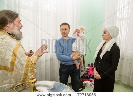 ALMATY KAZAKHSTAN - DECEMBER 17: Christening ceremony on December 17 2013 in Almaty Kazakhstan. Family celebrating baptism in Orthodox Church - Monastery of St. Matrona