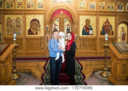 ALMATY KAZAKHSTAN - DECEMBER 17: Christening ceremony on December 17 2013 in Almaty Kazakhstan. Family celebrating baptism in Orthodox Church - Monastery of St. Matrona