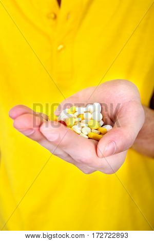 Person hold a Pills in the Hand closeup