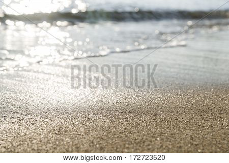 The sand of the beach washed by the waves of the sea