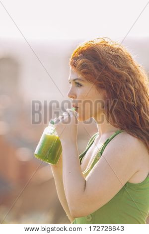 healthy lifestyle of young woman drinking a vitamins apple juice with a strow.
