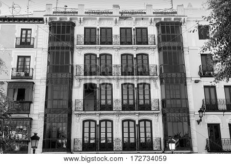 Toledo (Castilla-La Mancha Spain): facade of historic building with balconies and verandas in the Zocodover square. Black and white