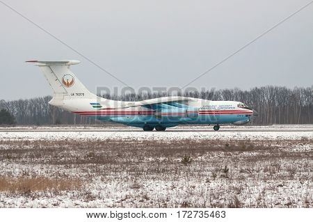 Kiev Region Ukraine - February 1 2011: Ilyushin Il-76 cargo plane taxiing along the runway after landing - side view