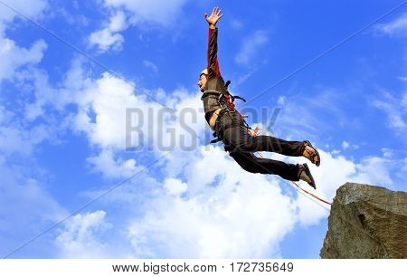 The first jump off the cliff with a safety rope.