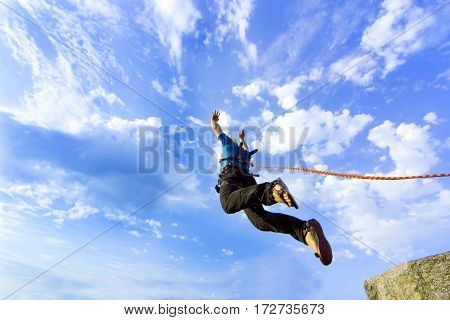 The first jump off the cliff with a safety rope.