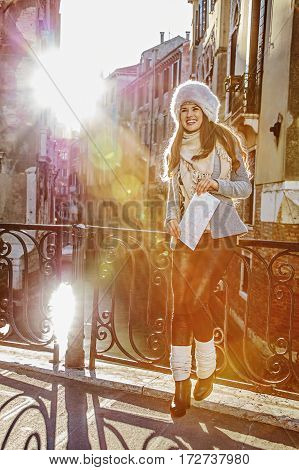 Happy Elegant Tourist Woman In Venice, Italy In Winter With Map