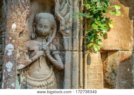 Ancient image of Khmer girl on the walls of the Preah Khan temple Siem Reip Cambodia