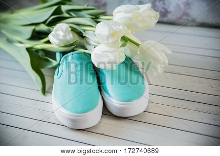 women's accessories, shoes lying on wooden background