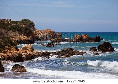 Waves crashing onto rocks at San Blas beach Gozo Malta