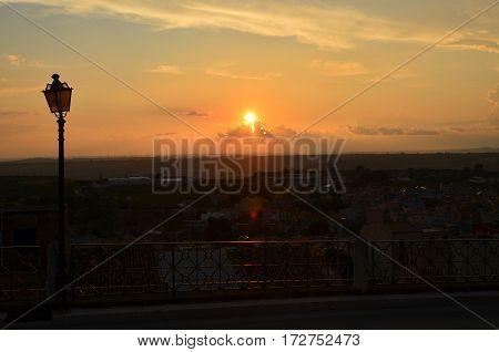 A Lit Vertical Lightposts with Sunrise Background