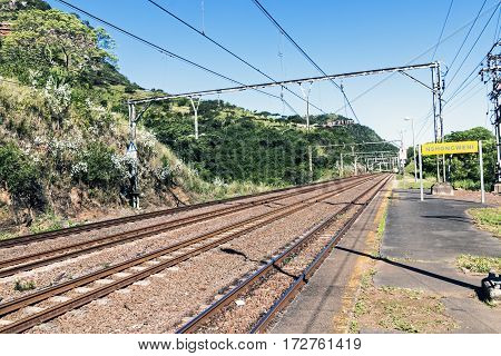 Twin Rail Tracks Leading Through Rural Railway Station