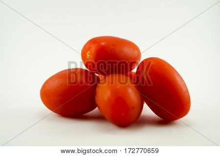 Tomato put on the white backgroundred color outstanding and fresh when you zoom it you can see water on tomato skin.
