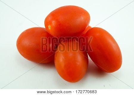 tomato overlap on the white backgroundred color outstanding and fresh when you zoom it you can see water on tomato skin.