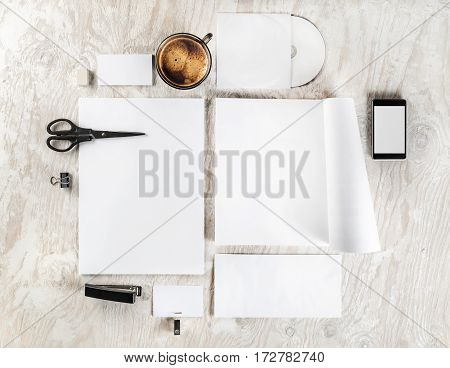 Photo of blank stationery and corporate identity template on light wooden table background. Mock up for branding identity. Responsive design mockup. Blank ID objects for placing your design. Top view.
