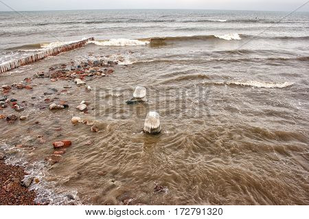 storm at sea with big waves on dark gloomy winter day