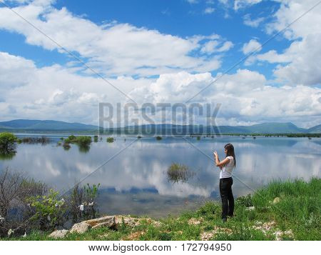 tourist taking pictures at a breathtaking lake in Croatia