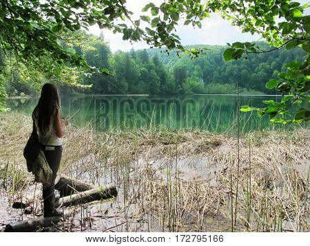 tourist woman isolated in the forest in Plitvice National Park