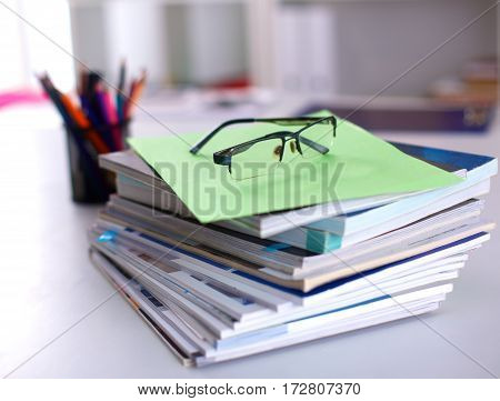 Group of multicolored office folders and glasses.