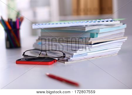Group of multicolored office folders and glasses.