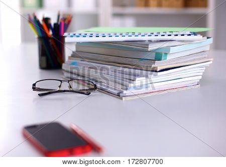 Group of multicolored office folders and glasses.