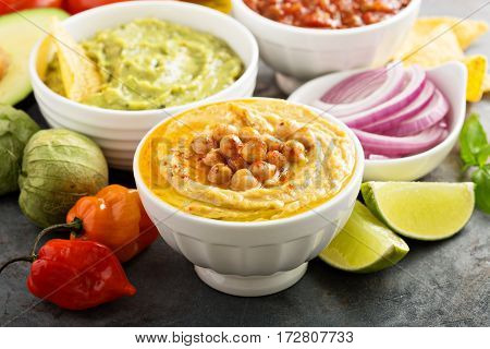 Guakamole and hummus dips with vegetables copy space