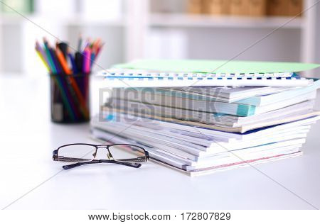 Group of multicolored office folders and glasses.