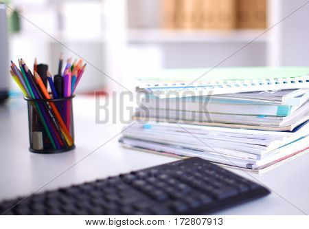 Group of multicolored office folders and glasses.