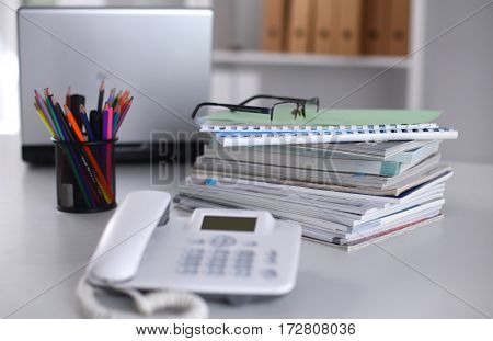 Group of multicolored office folders and glasses.