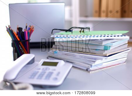 Group of multicolored office folders and glasses.