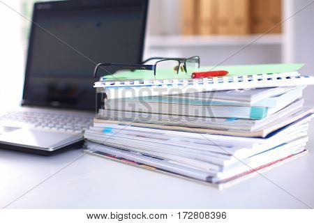 Group of multicolored office folders and glasses.