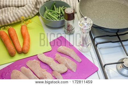 cooking at home kitchen chicken carrot and frying pan