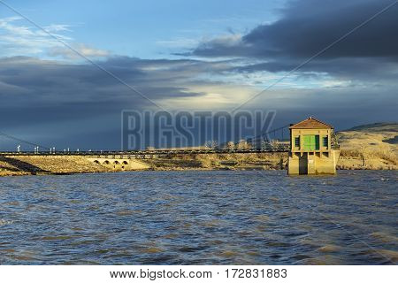 Flood control building at full reservoir at Sunset.  Lake Lahontan.  Shallow Depth of Field with focus on flood control tower.