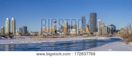 CALGARY, CANADA - FEB 11: Calgary downtown as viewed from the East Village along the Bow River on February 11, 2017 in Calgary, Alberta. The iconic Calgary Tower can be seen in the background.