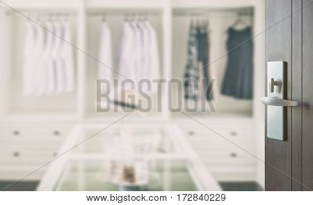 Opened Wooden Door To Closet Room With White Hat And Jewelry Set On A Table