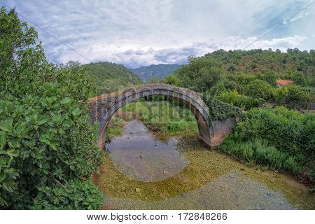 old arch stone bridge on the Zeta River, Montenegro