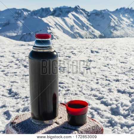 Thermos And A Cup Of Tea Bloated Stands On The Mark Border.