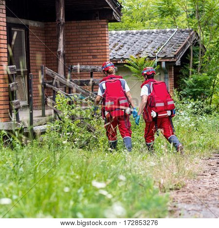 Rescue team helping injured female victim,  color image