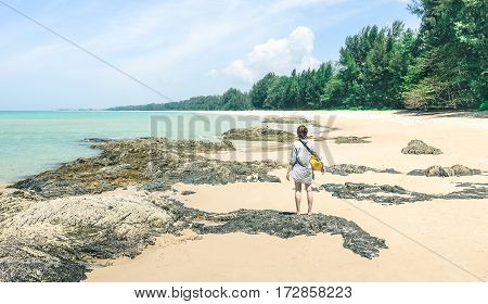 Young woman traveler with water bag enjoying sunny day at beach island hopping - Wanderlust travel concept with adventure girl tourist traveler on excursion in Thailand - Soft turquoise desat filter