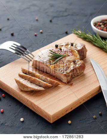 Homemade Roasted Pork Meat On Cutting Board With Cutlery, Herbs And Spices.