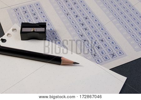 Filling Out In Answer Sheet With Pencil, Sharpener And Paper Reduction. Cross The Right Answer In Th
