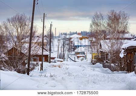 Snow-covered village street in Russian old-believer village Visim situated in the low Middle Ural Mountains of Sverdlovsk region, Russia
