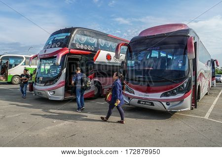 Menumbok,Sabah-Aug 19,2016:People running up to the bus in bus terminal at Menumbok,Sabah.People used to take bus from Kota Kinabalu to Menumbok then ferry to Labuan island to enjoy tax free shopping