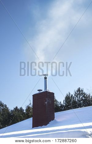 Snowy roof of the chimney from which smoke inside. 
Air pollution from households.