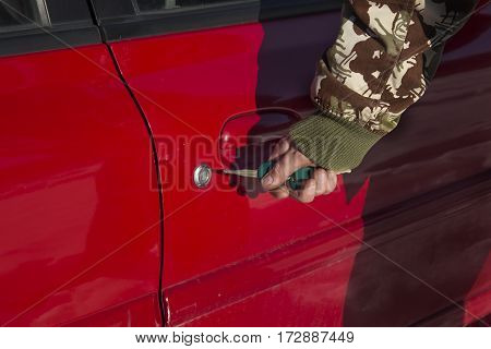 Opening lock the car with the key.
Closing lock the car with the key.
Men's hand puts the key into the lock of the car